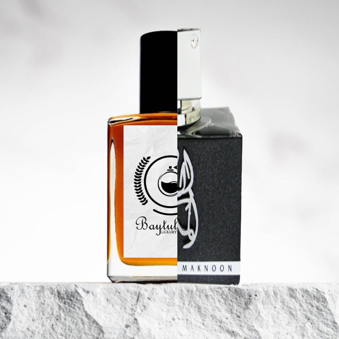 "A perfume bottle with a black cap and the 'Baytul' luxury logo, positioned on the left side on a textured surface."
"On the right, a perfume bottle of Al Dur Al Maknoon Silver by Lattafa."
"The two bottles are placed side by side, highlighting their distinct designs."
"The textured surface beneath the bottles adds depth and contrast to the image."
"Both bottles are elegantly displayed with the logo and design features clearly visible."