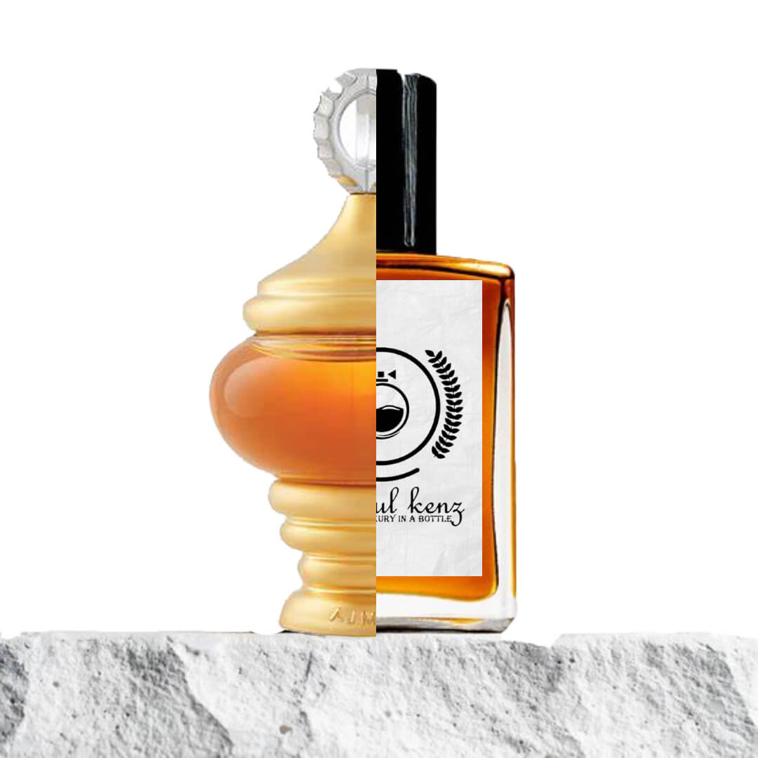 "Two contrasting perfume bottles side by side on a white surface."
"On the left, a spherical-shaped orange and gold-colored perfume bottle of Alf Lail O Lail by Ajmal."
"On the right, an amber-colored bottle of the Baytulkenz-inspired version of Ajmal Alf Lail O Lail."
"The two bottles are positioned next to each other, showcasing their distinct shapes and colors."
"The white surface beneath the bottles enhances their contrasting designs and vibrant colors."