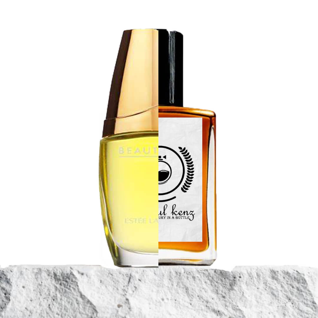 "Two perfume bottles are displayed side by side on a light stone surface."
"On the left, a gold-capped bottle with yellow liquid, representing Beautiful by Estée Lauder."
"The bottle has a classic, elegant design with a polished gold cap and soft yellow hue."
"On the right, an amber bottle with a label, the Baytulkenz inspired version of Beautiful by Estée Lauder."
"The amber bottle features a warm, rich color and a simple yet refined label."