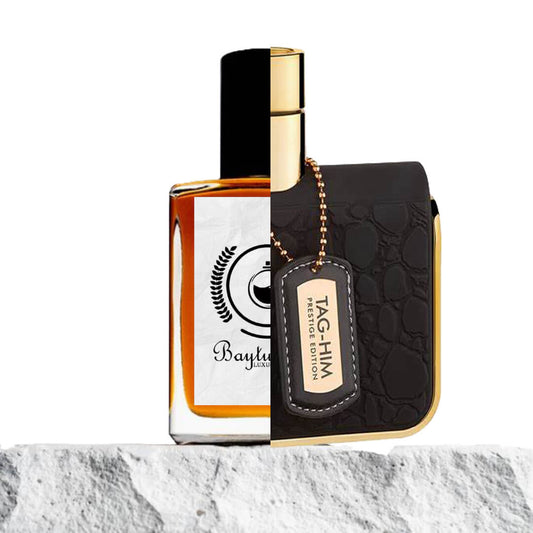 "Two cologne bottles are placed on a textured surface."
"On the left, an amber-colored bottle represents the Baytulkenz inspired version of "Tag Him Prestige Armaf."
"On the right, a black-colored bottle with a golden tag reads "Tag Him Prestige Armaf," showcasing an elegant design."
"The amber bottle contrasts with the sophisticated black bottle, highlighting the difference in color and labeling."